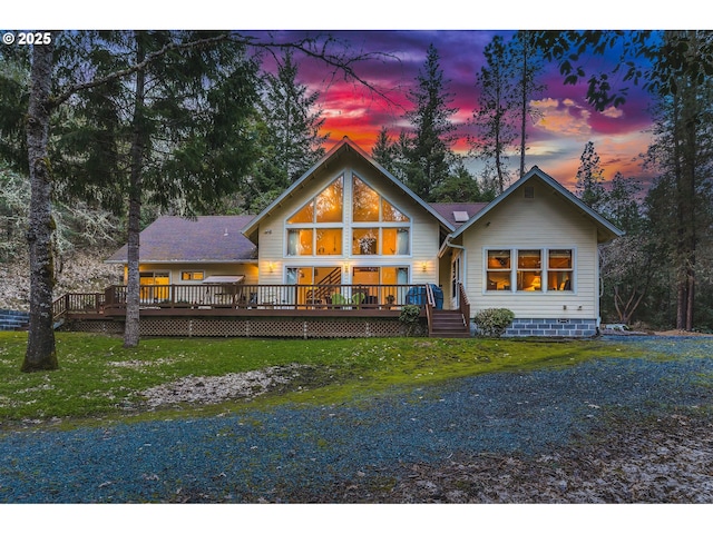 back of house with a lawn and a deck