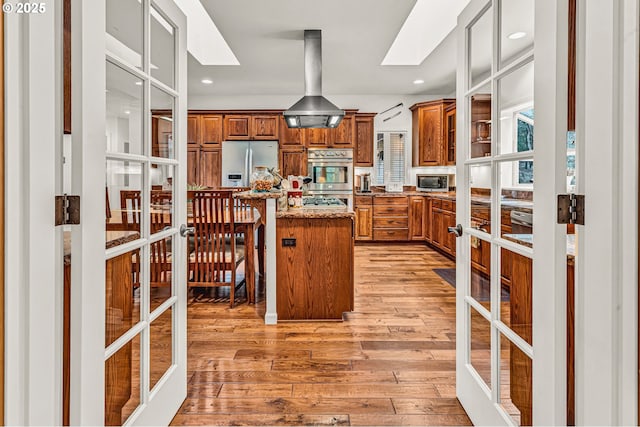780 Pinecrest Dr, Grants Pass, OR 97526 - kitchen featuring french doors, light wood finished floors, brown cabinets, and stainless steel appliances