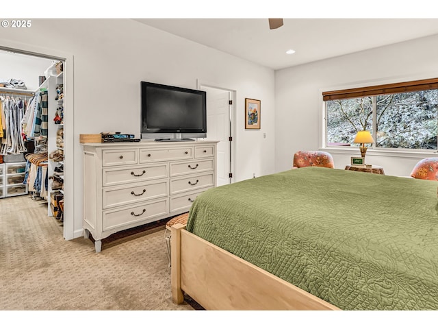 bedroom featuring a closet, light carpet, recessed lighting, a spacious closet, and a ceiling fan