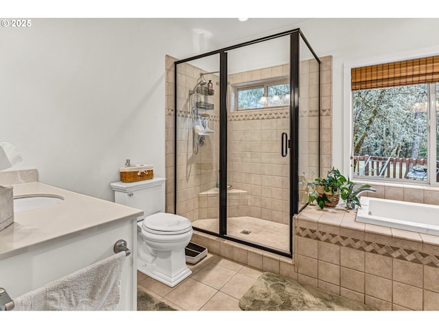 full bath featuring toilet, tile patterned floors, a shower stall, and a garden tub