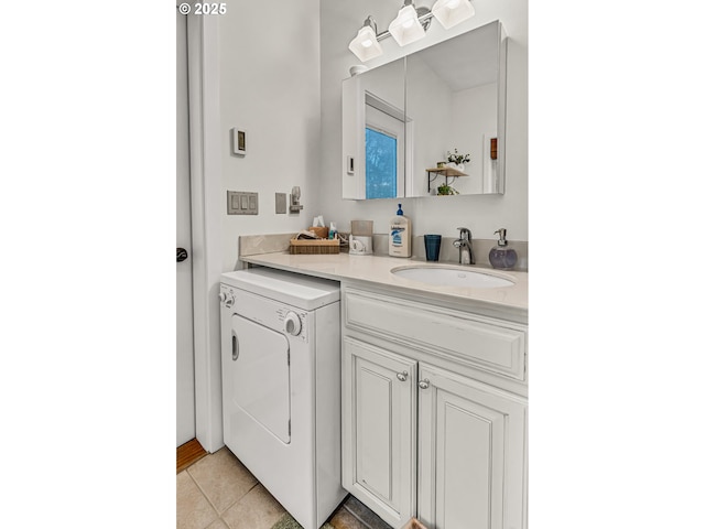 bathroom with washer / clothes dryer, tile patterned flooring, and vanity
