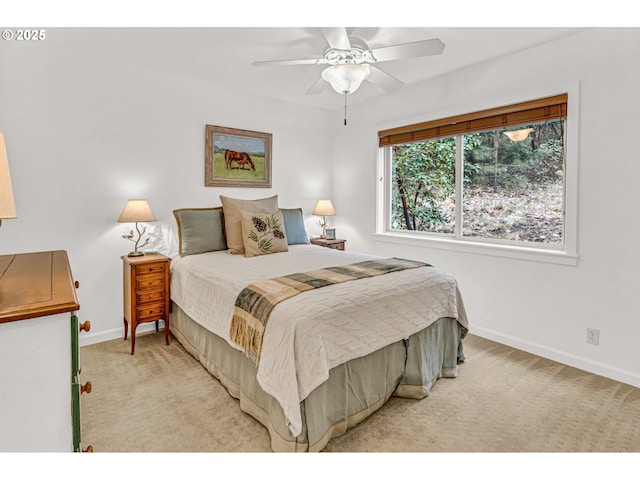 bedroom featuring light colored carpet, baseboards, and ceiling fan