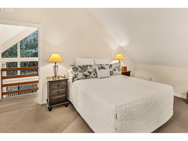 carpeted bedroom featuring baseboards and lofted ceiling