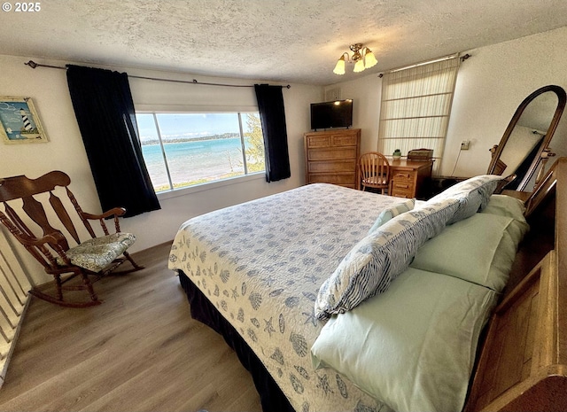 842 S Empire Blvd, Coos Bay, OR 97420 - bedroom featuring a textured ceiling and wood finished floors