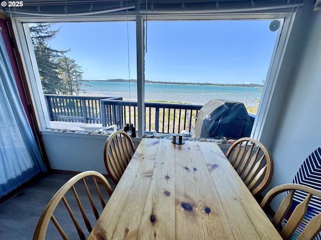 842 S Empire Blvd, Coos Bay, OR 97420 - dining area featuring a water view, wood finished floors, and healthy amount of natural light