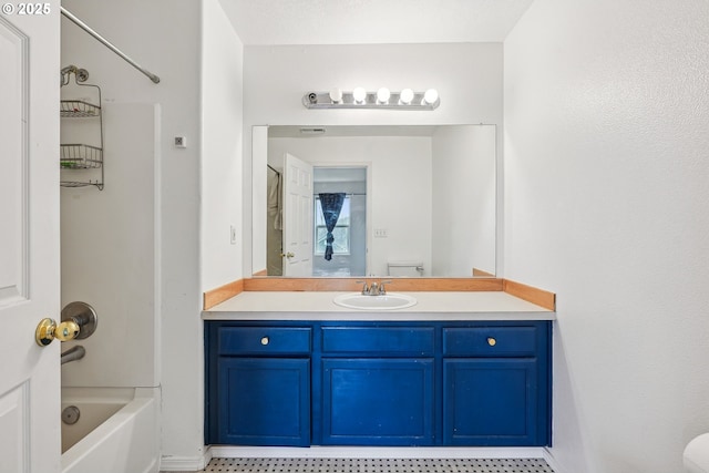 bathroom featuring vanity, toilet, and baseboards