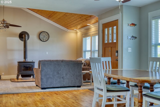 1732 Hayes St, North Bend, OR 97459 - dining area featuring a wood stove, a wealth of natural light, a ceiling fan, and wooden ceiling