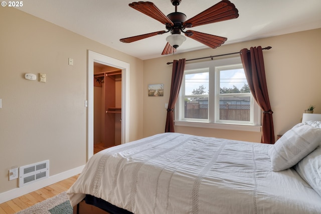 1732 Hayes St, North Bend, OR 97459 - bedroom featuring a ceiling fan, wood finished floors, a spacious closet, baseboards, and visible vents