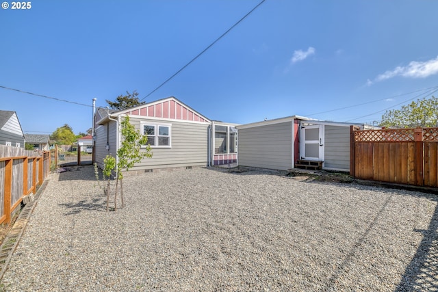 1732 Hayes St, North Bend, OR 97459 - back of house with board and batten siding, crawl space, and a fenced backyard