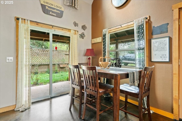 823 Terrace Dr, Scotts Mills, OR 97375 - dining space featuring a textured wall, baseboards, and concrete floors