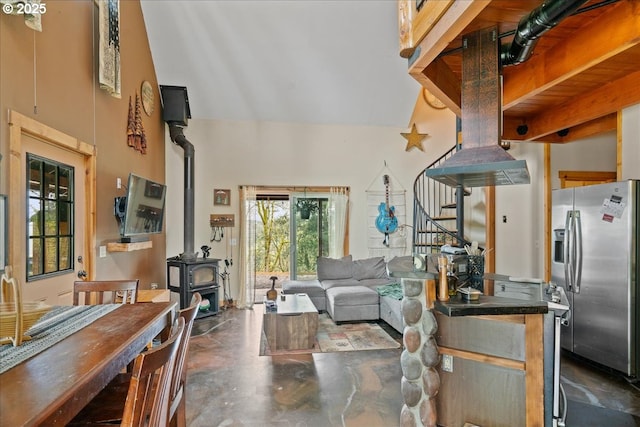 823 Terrace Dr, Scotts Mills, OR 97375 - living room featuring stairway, a high ceiling, concrete flooring, and a wood stove