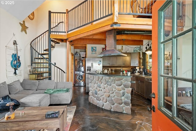 823 Terrace Dr, Scotts Mills, OR 97375 - living room featuring stacked washer and dryer, a towering ceiling, and stairs