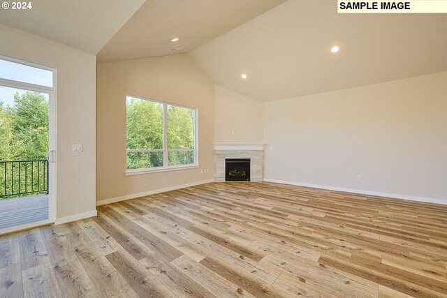 17367 SW Atfalati Ln Unit 42, Sherwood, OR 97140 - unfurnished living room featuring light wood finished floors, vaulted ceiling, recessed lighting, and a healthy amount of sunlight