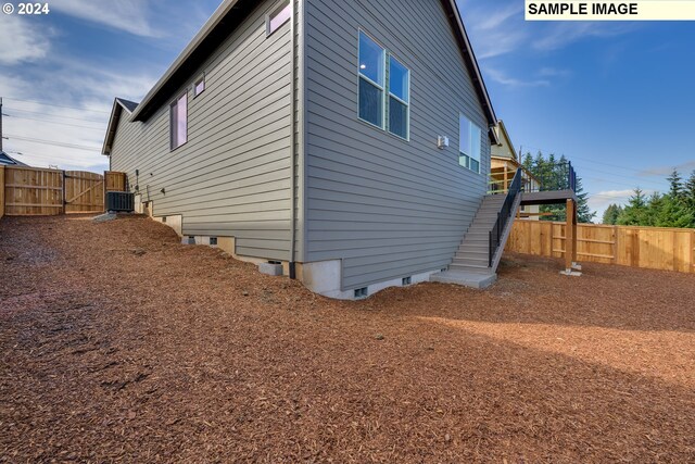 17367 SW Atfalati Ln Unit 42, Sherwood, OR 97140 - exterior space with a fenced backyard, stairway, cooling unit, and crawl space