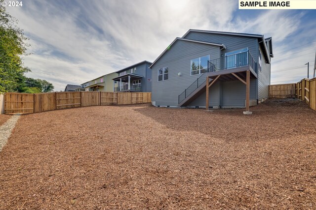 17367 SW Atfalati Ln Unit 42, Sherwood, OR 97140 - back of property featuring stairway, a fenced backyard, and a deck