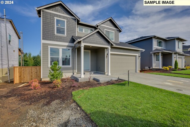 17367 SW Atfalati Ln Unit 42, Sherwood, OR 97140 - view of front facade with concrete driveway, an attached garage, fence, and a front lawn