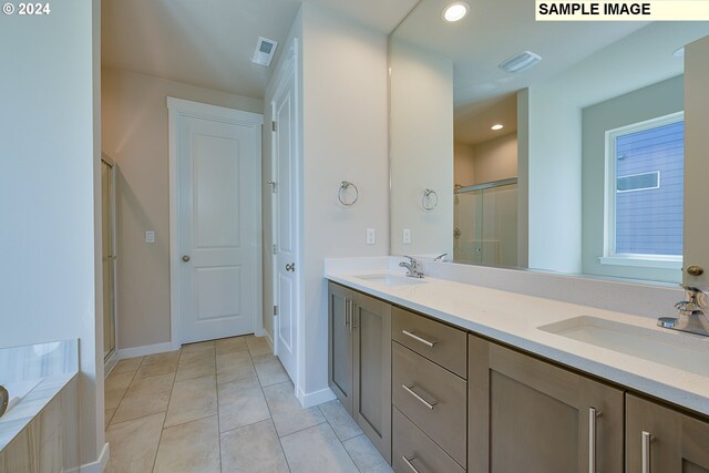 17367 SW Atfalati Ln Unit 42, Sherwood, OR 97140 - full bath with tile patterned floors, a sink, a shower stall, and double vanity