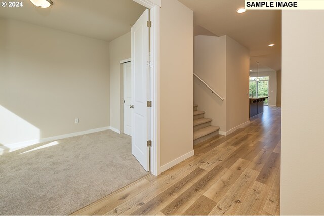17367 SW Atfalati Ln Unit 42, Sherwood, OR 97140 - hall with recessed lighting, baseboards, stairway, and light wood-style flooring