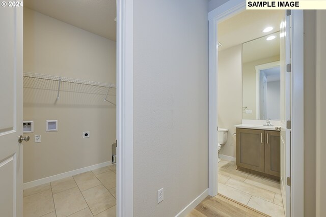 17367 SW Atfalati Ln Unit 42, Sherwood, OR 97140 - clothes washing area featuring laundry area, light tile patterned floors, a sink, hookup for an electric dryer, and hookup for a washing machine