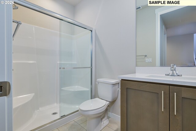 17367 SW Atfalati Ln Unit 42, Sherwood, OR 97140 - bathroom featuring toilet, baseboards, tile patterned flooring, a shower stall, and vanity