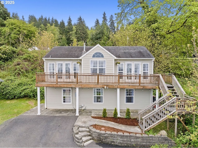 4841 Cedar St, Astoria, OR 97103 - view of front of property with driveway, a patio, stairway, a wooden deck, and roof with shingles