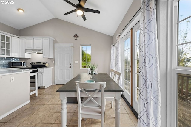 4841 Cedar St, Astoria, OR 97103 - dining area featuring light tile patterned floors, ceiling fan, and vaulted ceiling