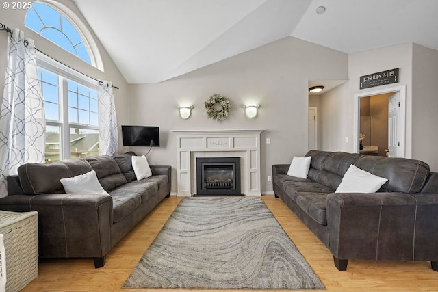 4841 Cedar St, Astoria, OR 97103 - living room with high vaulted ceiling, light wood-style flooring, and a fireplace with flush hearth