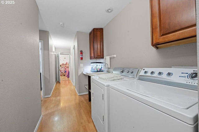 4841 Cedar St, Astoria, OR 97103 - clothes washing area with cabinet space, independent washer and dryer, light wood-type flooring, and baseboards