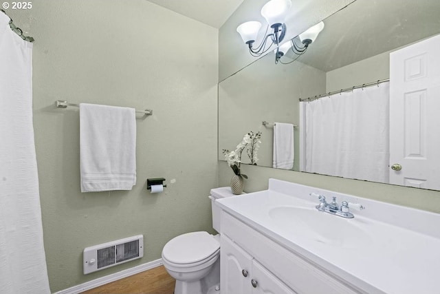 4841 Cedar St, Astoria, OR 97103 - bathroom with toilet, wood finished floors, vanity, visible vents, and baseboards