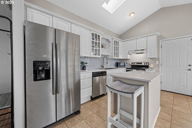 4841 Cedar St, Astoria, OR 97103 - kitchen with light tile patterned floors, under cabinet range hood, stainless steel appliances, and a sink