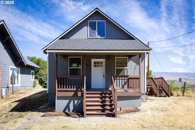 809 E 7th St, The Dalles, OR 97058 - view of front of property with a shingled roof, a porch, and stairway