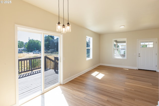 809 E 7th St, The Dalles, OR 97058 - unfurnished dining area with light wood finished floors and a chandelier