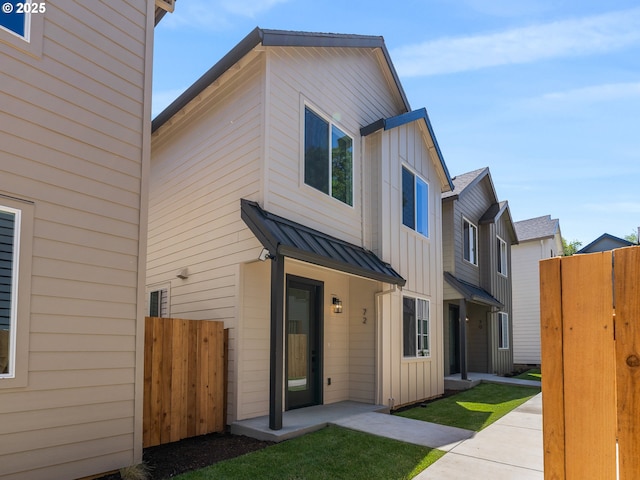72 NE Stanton, Portland, OR 97212 - view of front facade with board and batten siding, a standing seam roof, and a metal roof