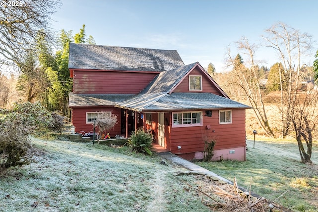 rear view of house with a lawn