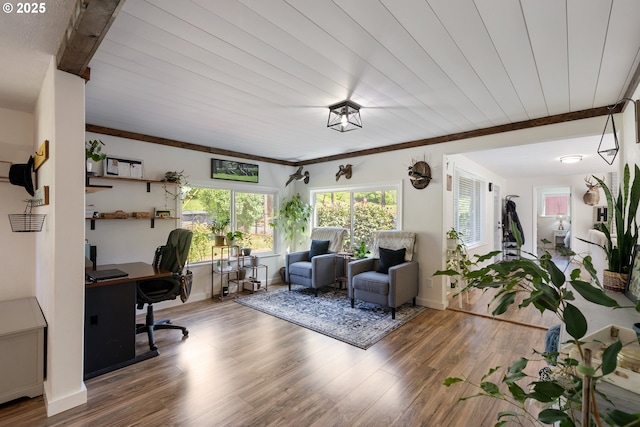 interior space with baseboards, ornamental molding, and wood finished floors