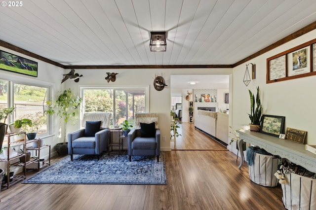 living area featuring ornamental molding and wood finished floors