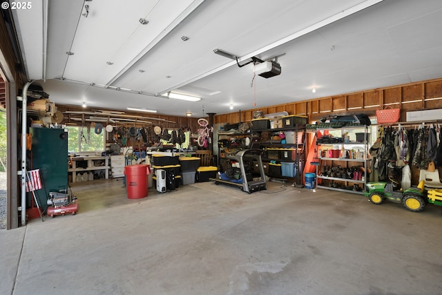 garage with a garage door opener and a workshop area