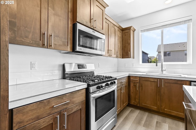 2095 S Heather St, Cornelius, OR 97113 - kitchen with appliances with stainless steel finishes, light wood-style floors, and light countertops