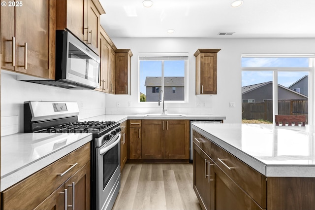 2095 S Heather St, Cornelius, OR 97113 - kitchen with appliances with stainless steel finishes, light wood-type flooring, recessed lighting, and light countertops