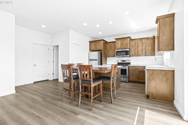 2095 S Heather St, Cornelius, OR 97113 - kitchen featuring stainless steel appliances, a center island, light wood finished floors, and recessed lighting