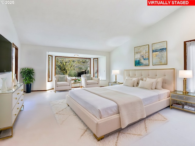 bedroom with carpet and vaulted ceiling
