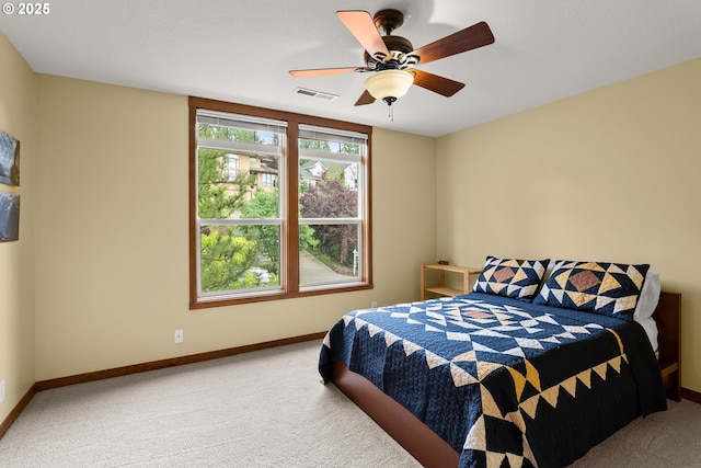 carpeted bedroom featuring baseboards and ceiling fan