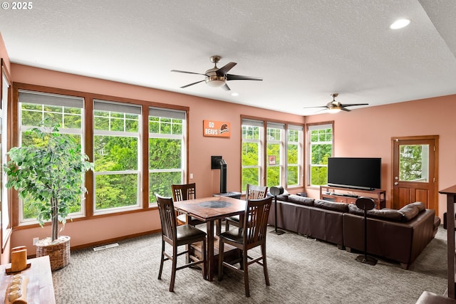 dining space with light carpet, ceiling fan, a textured ceiling, and recessed lighting