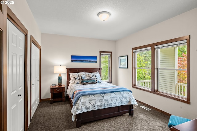 carpeted bedroom featuring baseboards