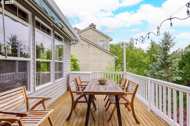 wooden deck featuring outdoor dining space