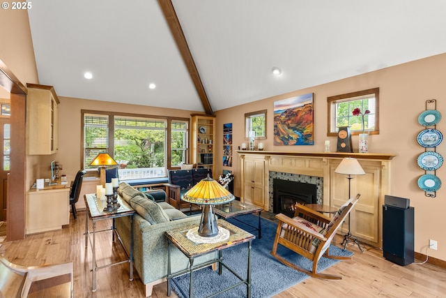 living room with light wood finished floors, a fireplace, recessed lighting, and baseboards