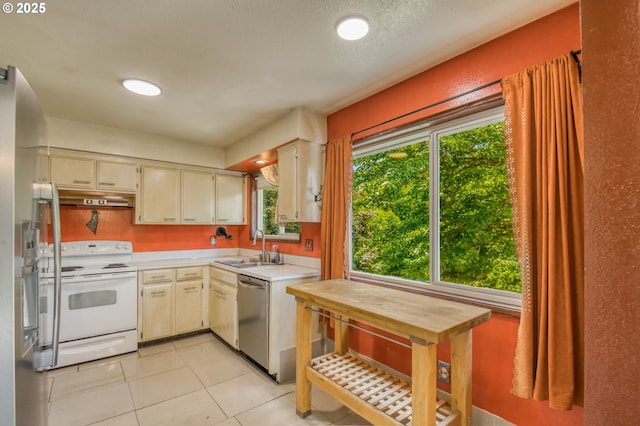 14173 NW Grandview Pl, Banks, OR 97106 - kitchen with white electric stove, stainless steel dishwasher, under cabinet range hood, a sink, and light countertops