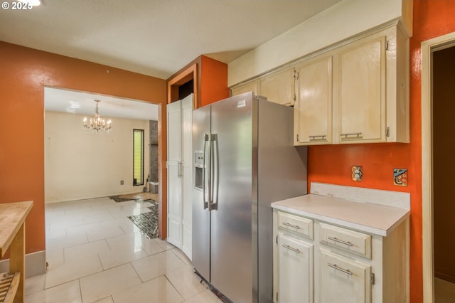 14173 NW Grandview Pl, Banks, OR 97106 - kitchen featuring stainless steel refrigerator with ice dispenser, light countertops, a chandelier, and hanging light fixtures