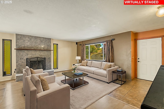 14173 NW Grandview Pl, Banks, OR 97106 - living room featuring a textured ceiling, a large fireplace, and light wood-style floors
