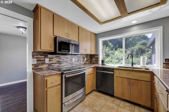 1168 Risden Pl, Eugene, OR 97404 - kitchen featuring stainless steel appliances, backsplash, recessed lighting, light tile patterned flooring, and dark stone counters